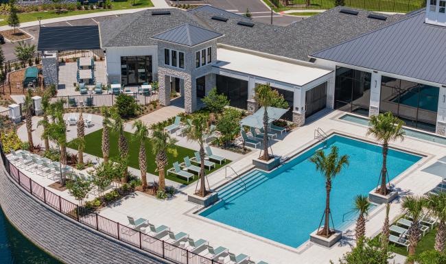 a building with a pool and palm trees