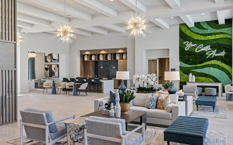 a lounge room with a chandelier and chairs