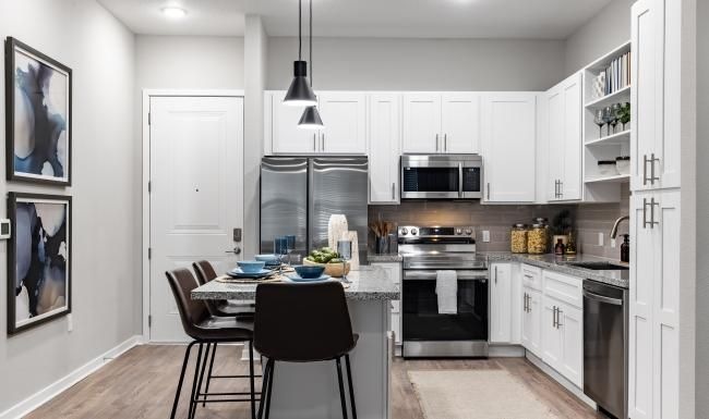 a kitchen with white cabinets